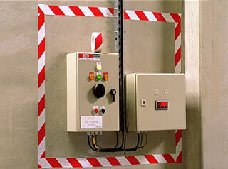 Red and white striped vinyl tape around electrical panel